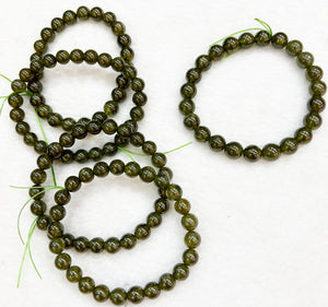Bracelet of natural stone beads of green hessonite attracting stones