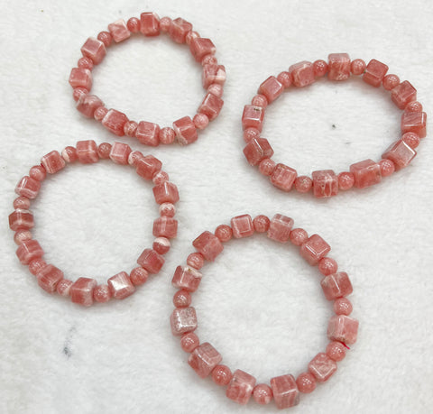 Bracelet of natural stone beads of rhodachrosite attracting stones